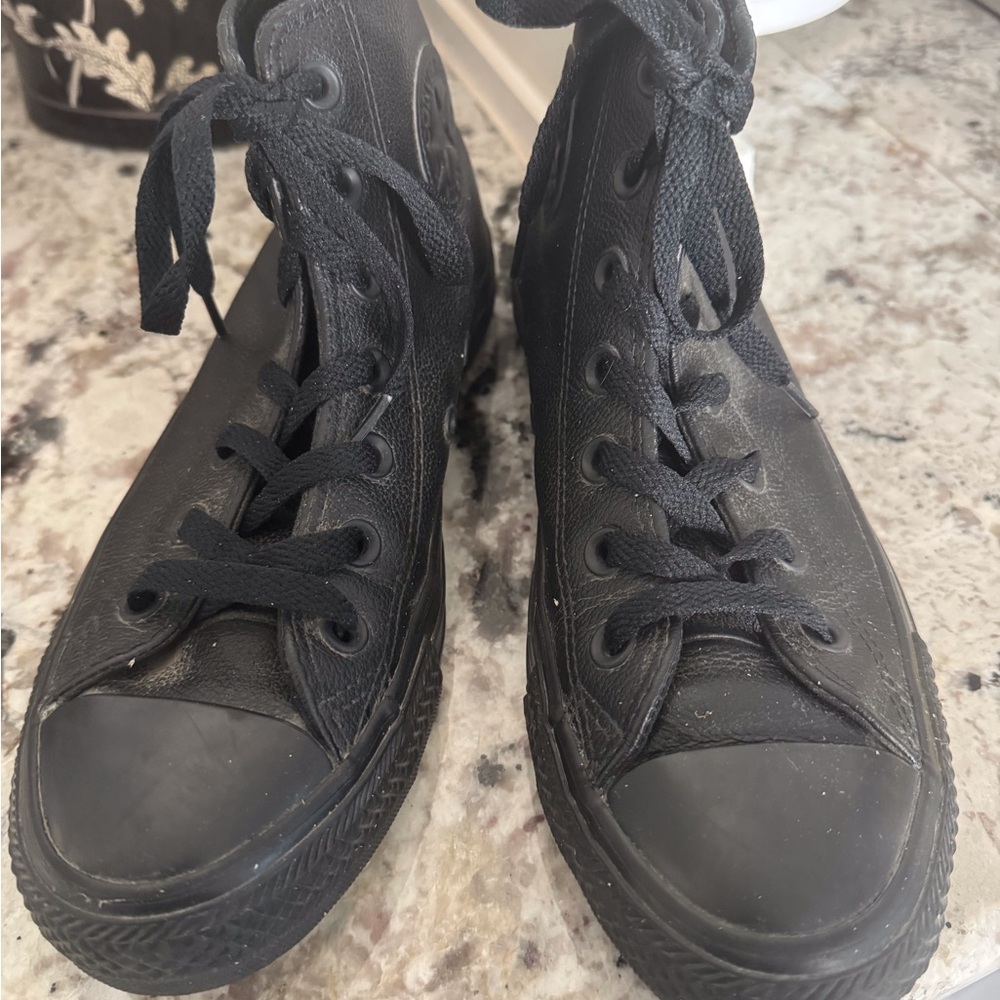 Men’s black leather high top Converse sneakers. They are men’s size 5.5